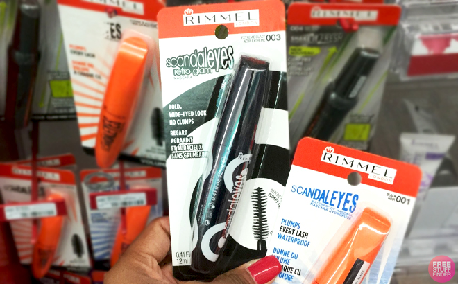 A Hand holding Rimmel Scandaleyes Mascaras