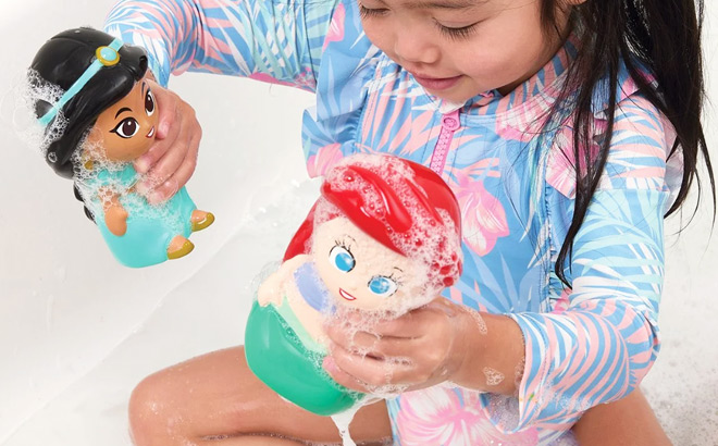 A Little Girl Playing with Disney Princess Bath Squirters