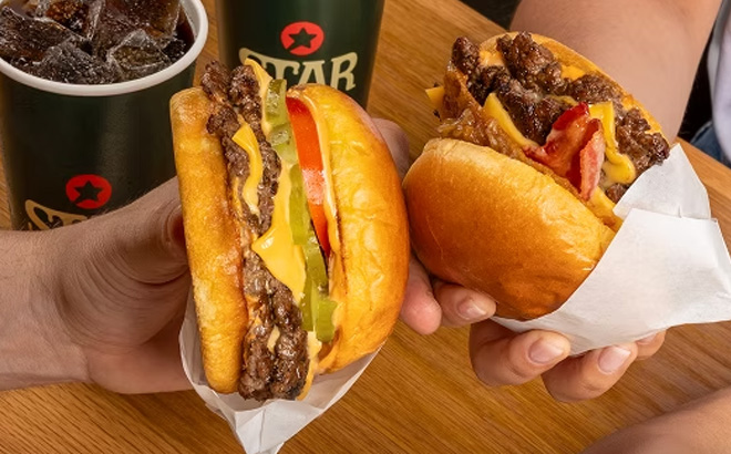 A Person Holding Burgers A Person Holding Burgers