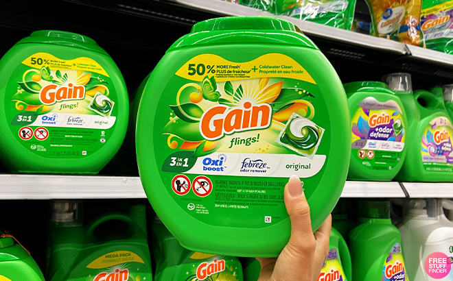 A Person Holding Gain flings Laundry Detergent