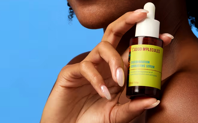 A Woman Holding Good Molecules Discoloration Correcting Serum A Woman Holding Good Molecules Discoloration Correcting Serum