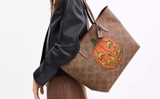A Woman Wearing Coach Outlet City Tote Bag In Signature Canvas With Halloween Print A Woman Wearing Coach Outlet City Tote Bag In Signature Canvas With Halloween Print