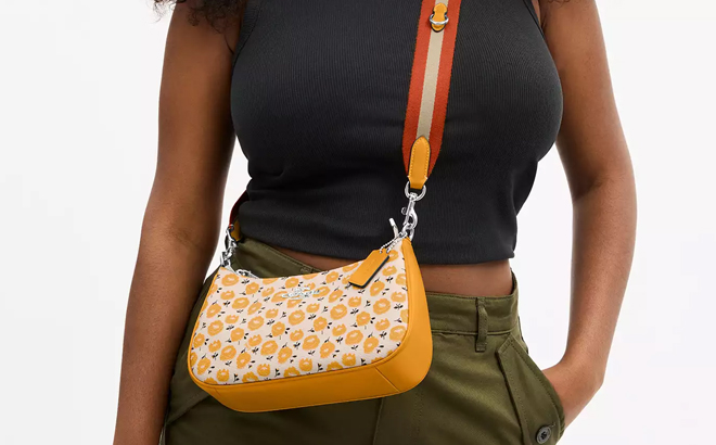 A Woman Wearing Coach Outlet Teri Shoulder Bag With Floral Print A Woman Wearing Coach Outlet Teri Shoulder Bag With Floral Print