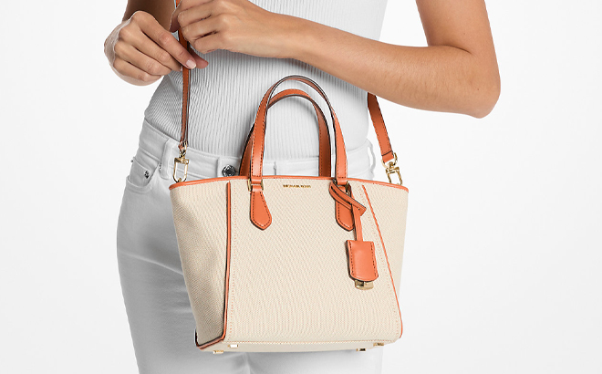 A Woman Wearing Michael Kors Taryn Small Canvas Convertible Crossbody Bag