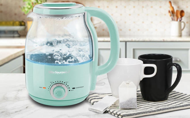 Elite Gourmet 1 2L Adjustable Temp Electric Honeypot Glass Kettle on the Table