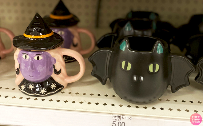 Hyde EEK Halloween Figural Witch Mug with Lid and Halloween Figural Bat Mug on a Store Shelf Hyde EEK Halloween Figural Witch Mug with Lid and Halloween Figural Bat Mug on a Store Shelf