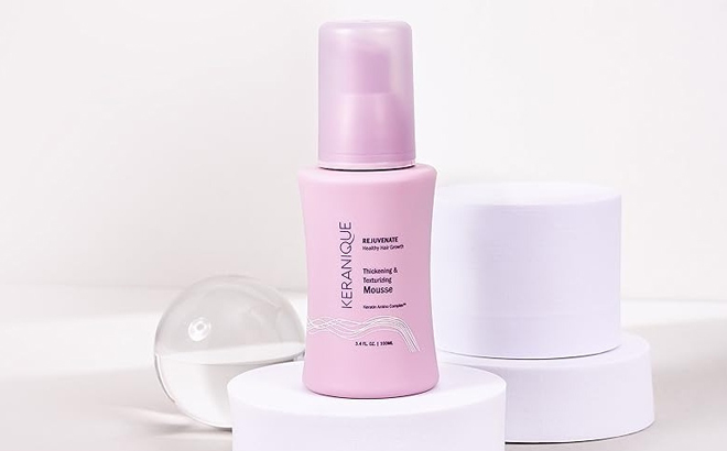 Keranique Thickening and Texturizing Mousse on a Product Stand