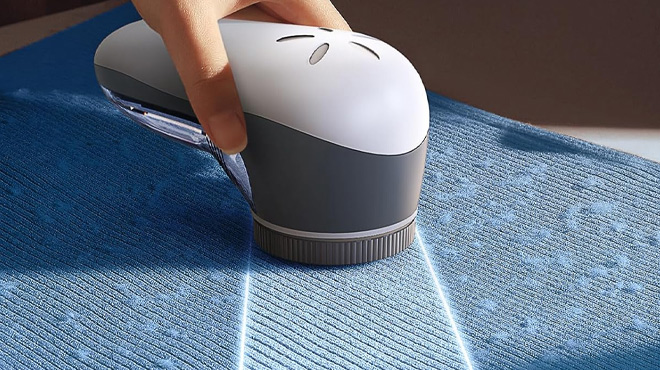 a Person Using Fabric Shaver a Person Using Fabric Shaver