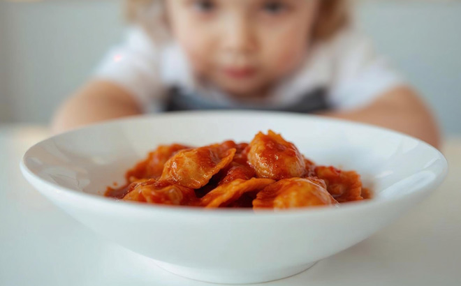 A Child Eating Chef Boyardee Beef Ravioli