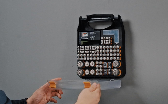 A Man Using the Amazon Basics Battery Organizer