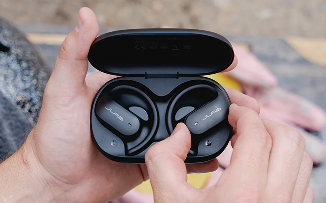 A Person Holding JLab Jbuds Open Sport Air Conduction Bluetooth Wireless Earbuds