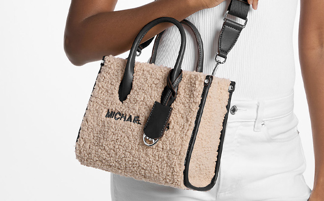 A Person Holding Michael Kors Mirella Small Faux Shearling Crossbody Bag