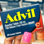 A Person Holding a Box of Advil Ibuprofen Tablets