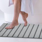 A Person stepping on a Foldable Stone Bath Mat