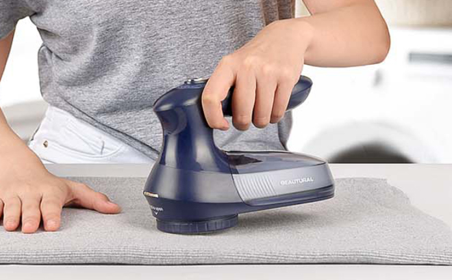 A Person using a Beautural Fabric Shaver and Lint Remover A Person using a Beautural Fabric Shaver and Lint Remover