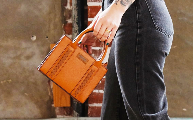 A Woman Holding a Wrangler Mini Tote Bag