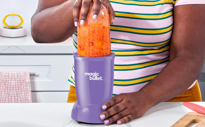 A Woman Using the Magic Bullet Essential with To Go Lid