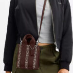 A Woman Wearing Coach Outlet Smith Mini Tote Bag In Signature Jacquard