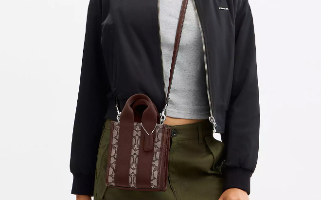 A Woman Wearing Coach Outlet Smith Mini Tote Bag In Signature Jacquard