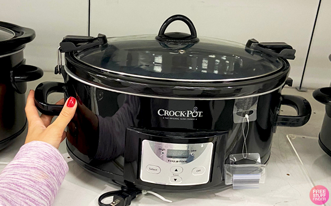 Crock Pot 7 Quart Countdown Cook Carry Slow Cooker on a Store Shelf Crock Pot 7 Quart Countdown Cook Carry Slow Cooker on a Store Shelf