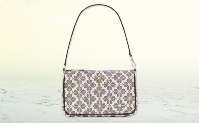 Kate Spade Spade Flower Convertible Wristlet on a Marble Tabletop Kate Spade Spade Flower Convertible Wristlet on a Marble Tabletop