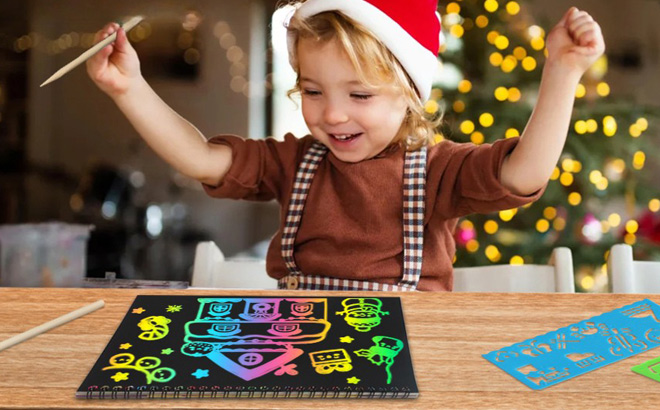 A Child Playing with Christmas Rainbow Scratch Paper A Child Playing with Christmas Rainbow Scratch Paper