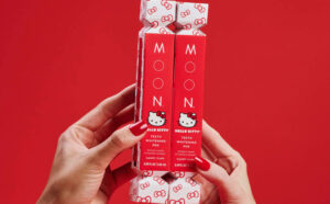 A Person Holding Two Moon x Hello Kitty Teeth Whitening Pen