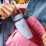 A Person Putting a Hydro Flask Micro Water Bottle in a Purse