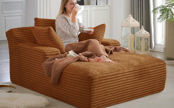 A Person Sitting on a Latitude Run Chaise Lounge Chair A Person Sitting on a Latitude Run Chaise Lounge Chair