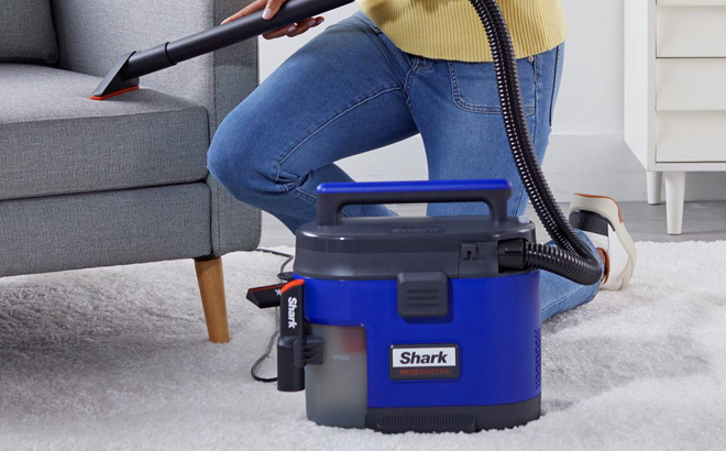 A Person Using Shark Mess Master Portable Vacuum with Home Car Kit