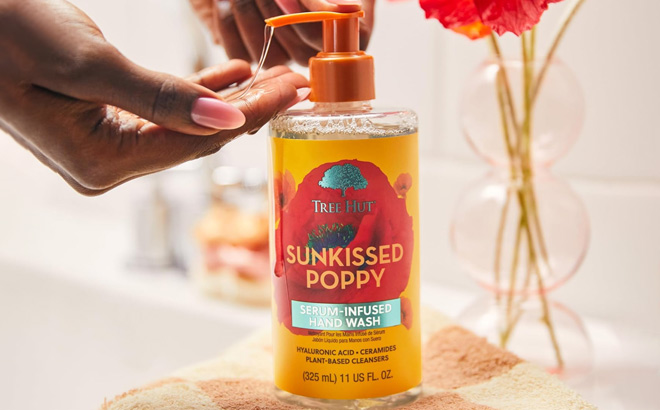 A Person Using Tree Hut Sunkissed Poppy Serum Infused Hand Wash