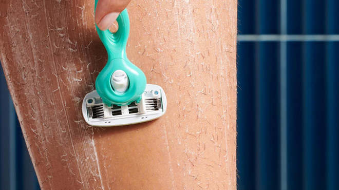 A Person Using a Schick Hydro Silk Sensitive Womens Razor