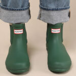 A Person Wearing Hunter Chelsea Rain Boots in Green Color