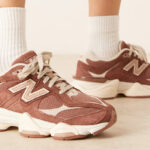 A Person Wearing New Balance 9060 Unisex Sneakers in Brown Color