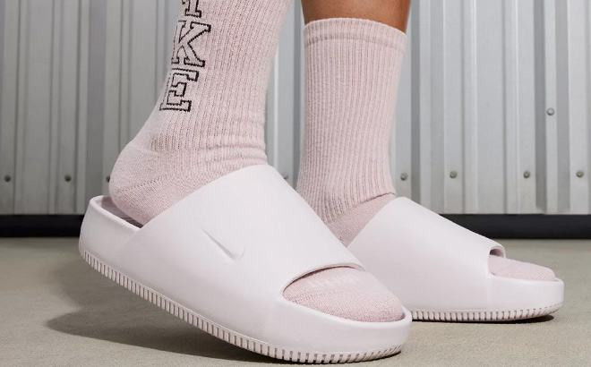 A Person Wearing Nike Womens Nike Calm Slide Sandals
