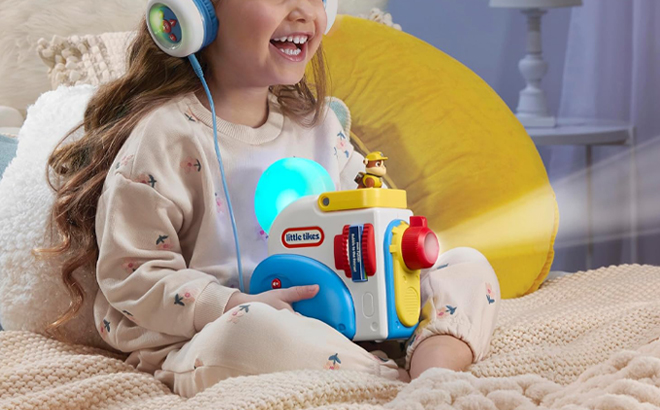A Person using a Little Tikes PawPatrol Story Dream Machine