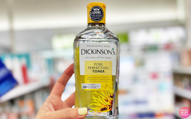A Prson Holding a Bottle of Dickinsons Original Witch Hazel Pore Perfecting Toner