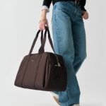 A Woman Holding Kate Spade Carter Nylon Large Weekender