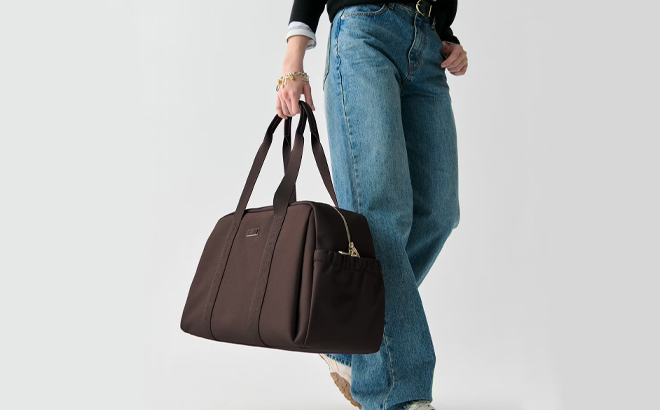 A Woman Holding Kate Spade Carter Nylon Large Weekender