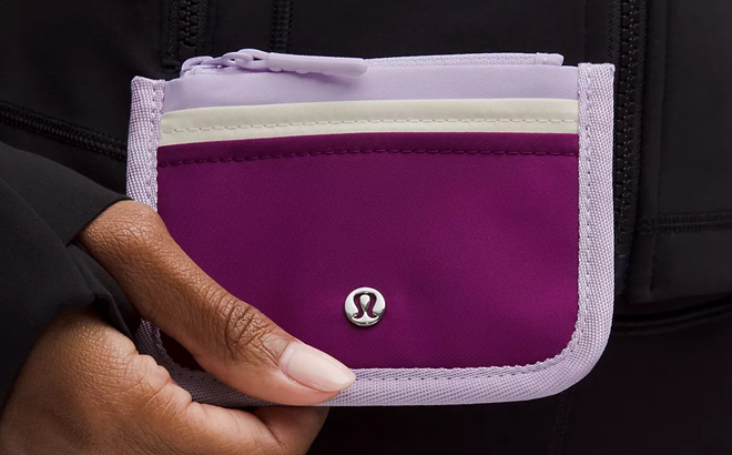 A Woman Holding Lululemon True Identity Card Case