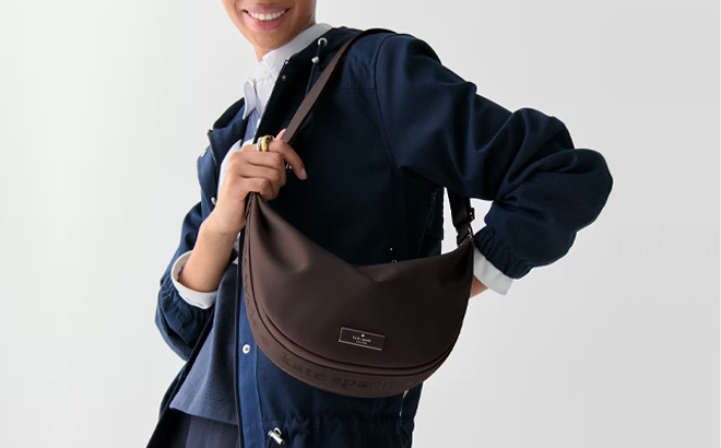 A Woman Wearing Kate Spade Carter Nylon Medium Sling Bag