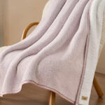 UGG Classic UGGfluff Throw in ay Fog Color on a Chair