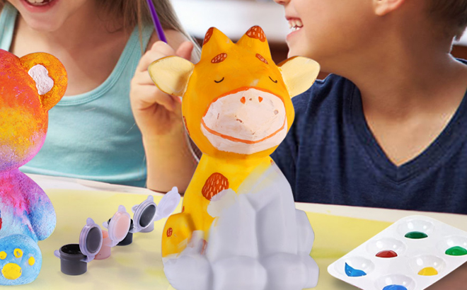 A Child painting a Deer Lamp