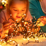 A Girl Untangling JACKYLED Christmas String Lights