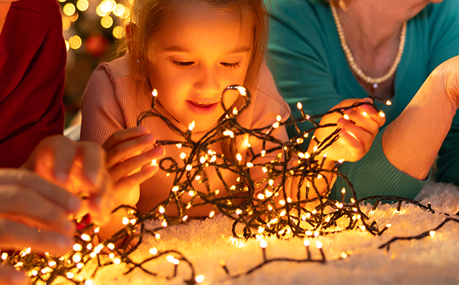 A Girl Untangling JACKYLED Christmas String Lights
