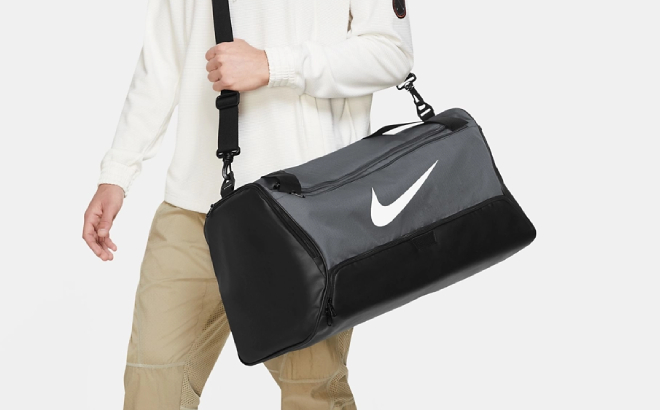 A Person Carrying a Nike Brasilia M 9 5 Duffel Bag