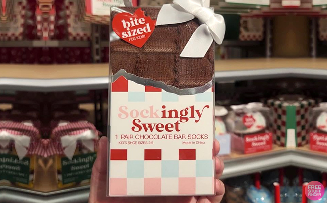 A Person Holding Sockingly Sweet Kids Chocolate Bar Christmas Crew Socks
