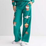 A Person Wearing Licensed Character Juniors Wide Leg Fleece Pants with Hello Kitty Graphics