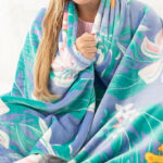A Person cuddled in a Care Bears x Lug Cuddle Throw