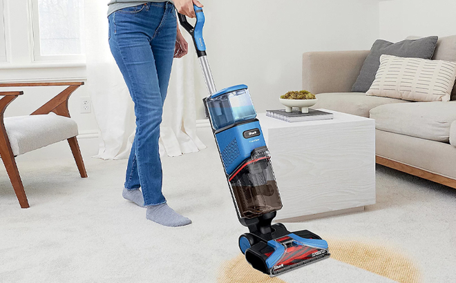 A Person using Shark CarpetXpert Carpet Cleaner